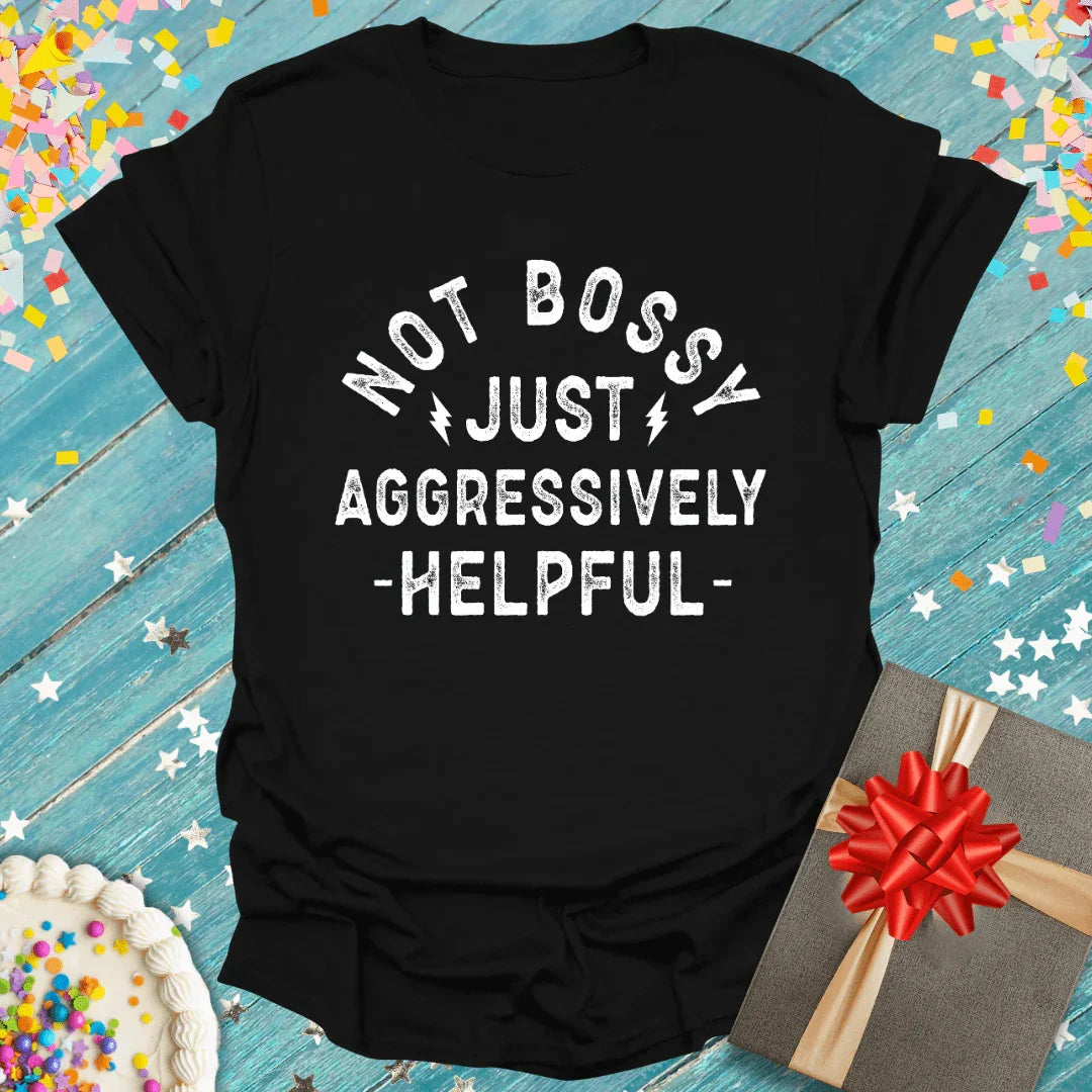 Black T-shirt with Not Bossy Just Aggressively Helpful text, surrounded by confetti, cake, and gift box