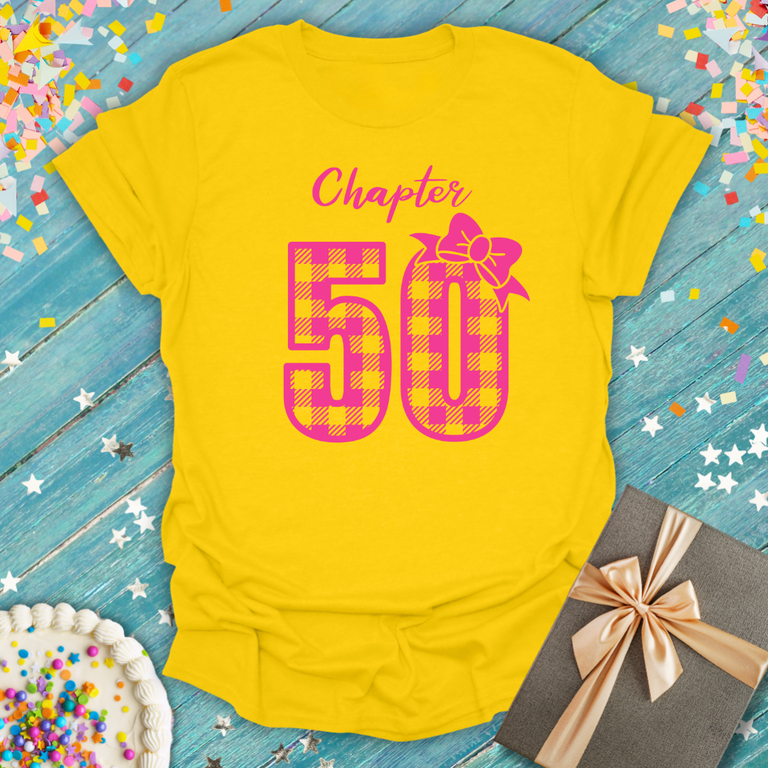 Epic Era Tees yellow Chapter 50 Pink Check Birthday T-Shirt with pink buffalo plaid numbers and a bow.