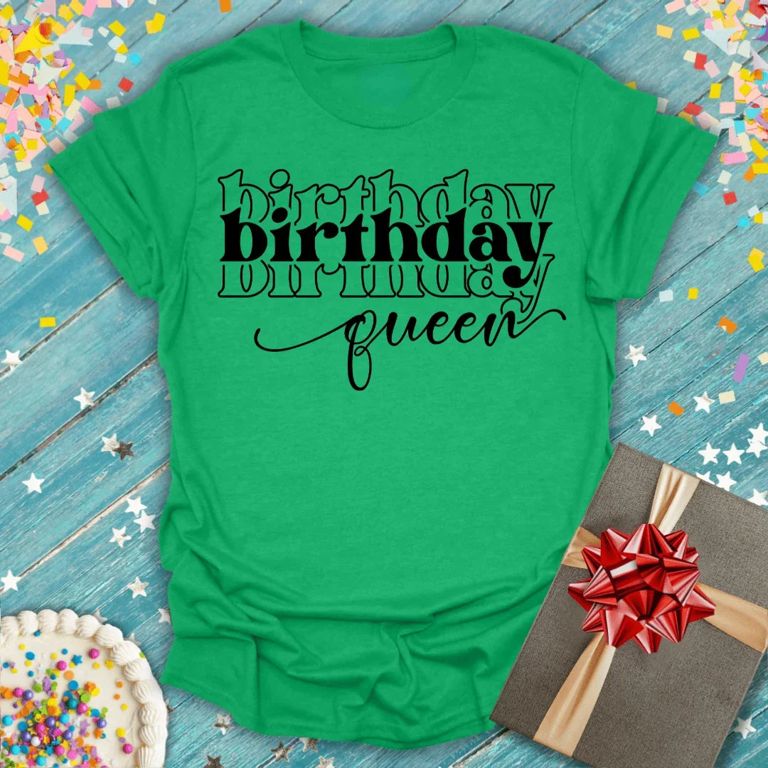 Green birthday queen tee with confetti, cake, and gift on blue wood background