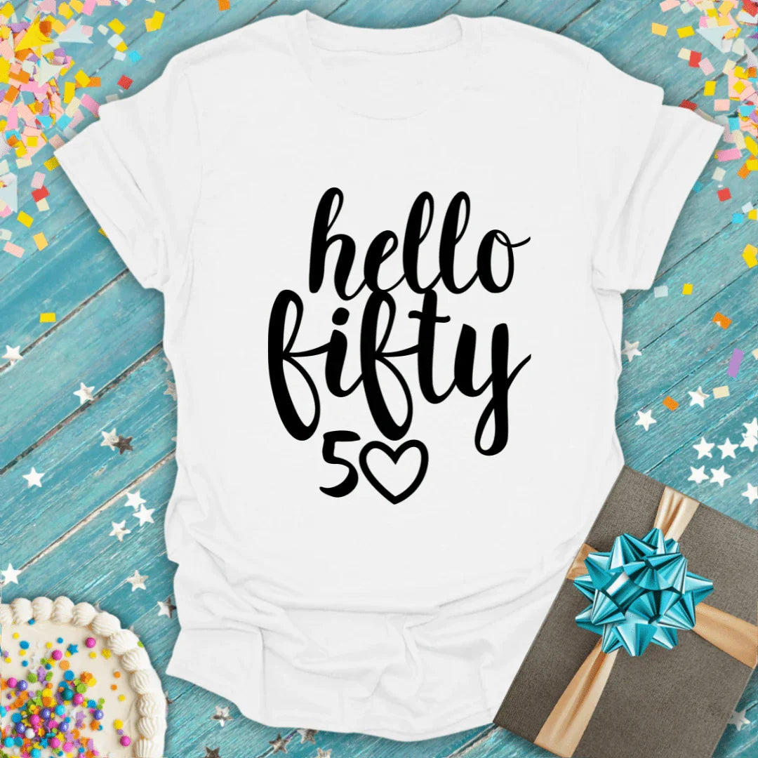 White T-shirt with 'hello fifty 50' text, surrounded by confetti, birthday cake, and gift box