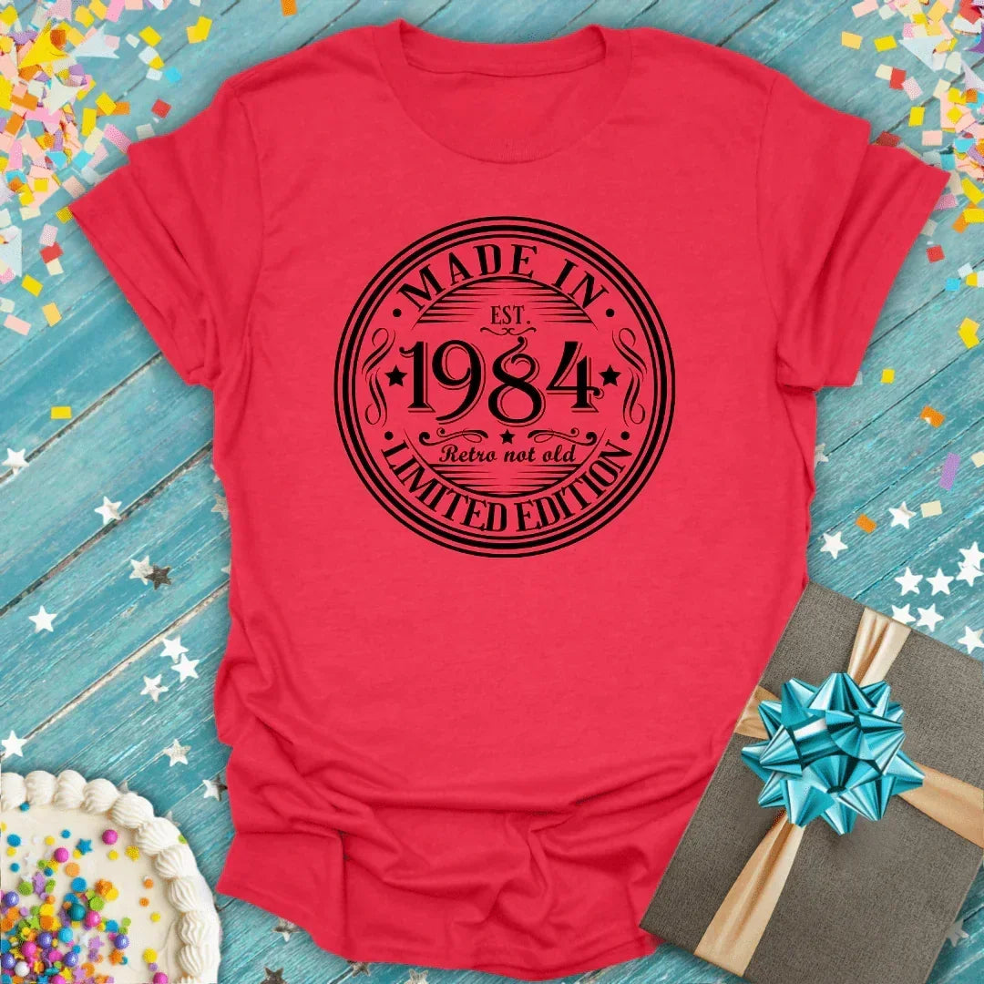 Red 'Made in 1984' retro tee with birthday cake and gift, perfect for milestone celebrations.