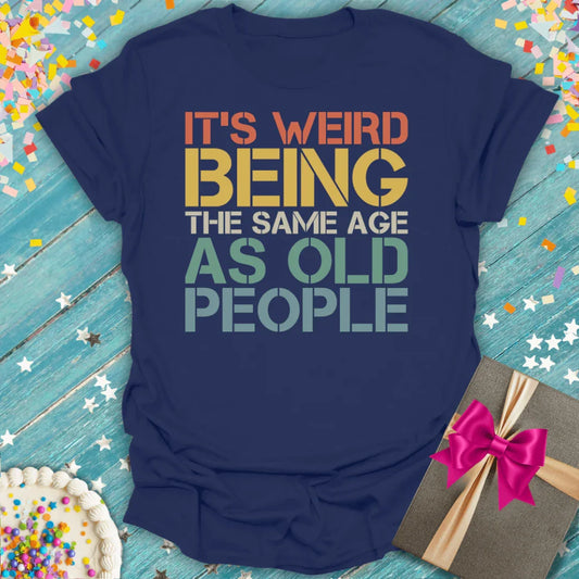 Navy blue retro birthday T-shirt with funny text, surrounded by confetti, cake, and gift.