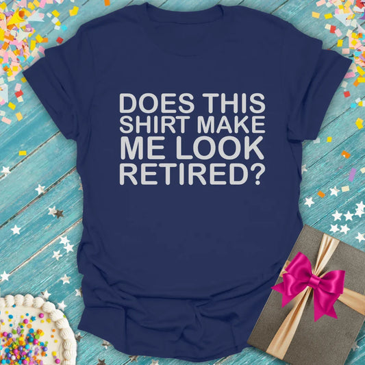 Navy blue funny retirement t-shirt with 'Does This Shirt Make Me Look Retired?' text, gift box, and cake on confetti background