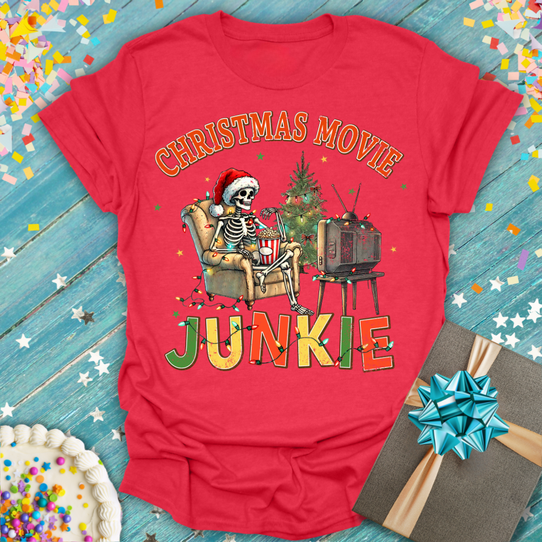 Red Epic Era Tees Retro Christmas Movie Junkie T-Shirt featuring a skeleton watching TV with a tree.