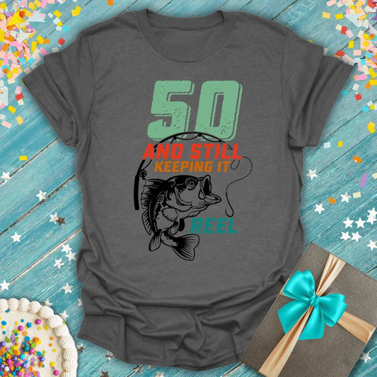 Epic Era Tees charcoal grey shirt with '50 AND STILL KEEPING IT REEL' fishing graphic.