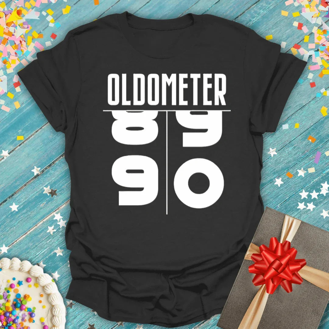 Black 'Oldometer 89 to 90' birthday tee with confetti, cake, and gift — perfect for milestone celebrations.