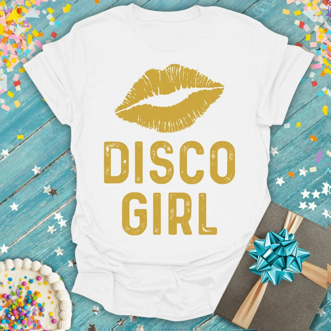 White 'Disco Girl' tee with gold lips, perfect for birthdays or trips, styled with cake and gift.