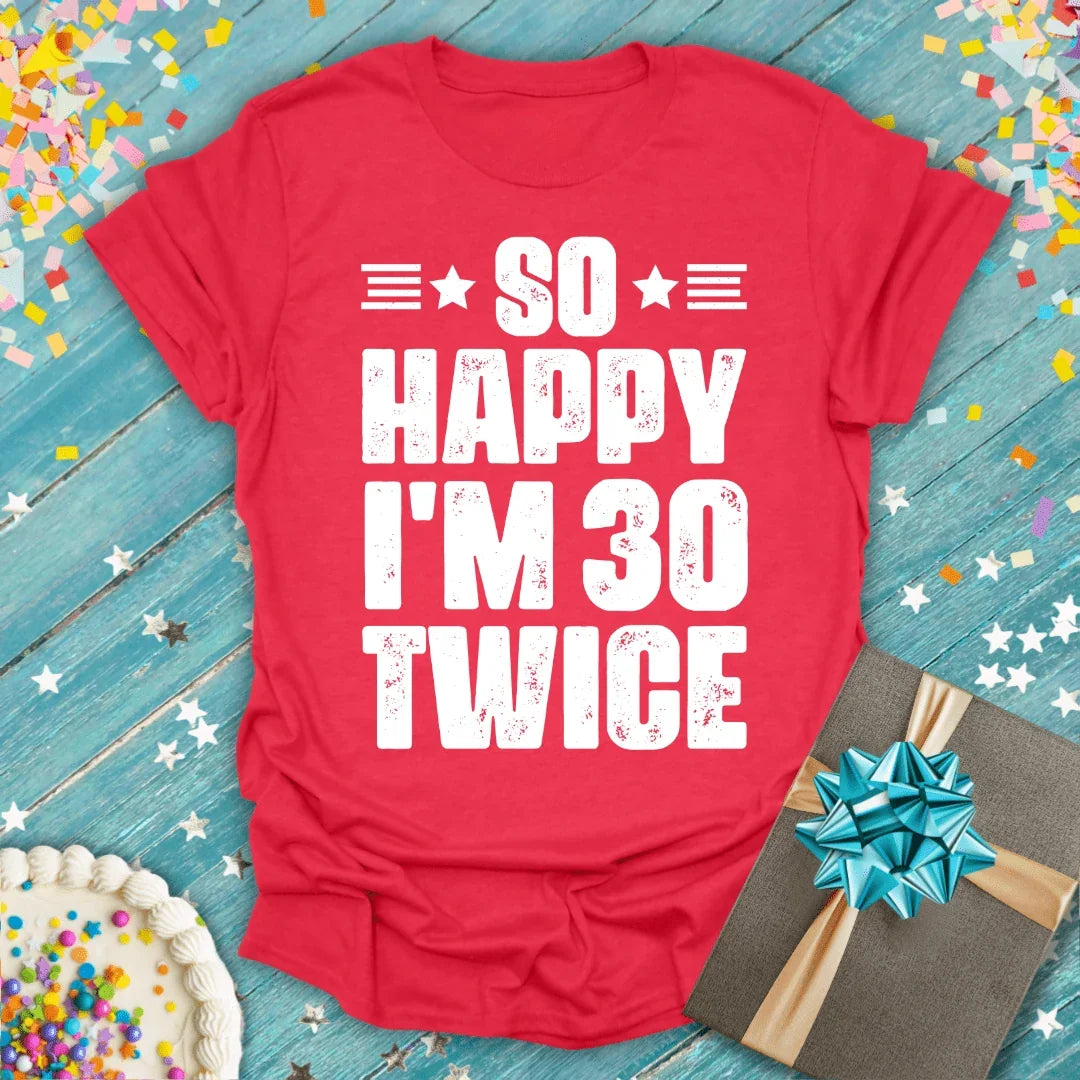 Red birthday tee saying 'So Happy I'm 30 Twice' with cake, gift, and confetti—perfect for milestone celebrations.
