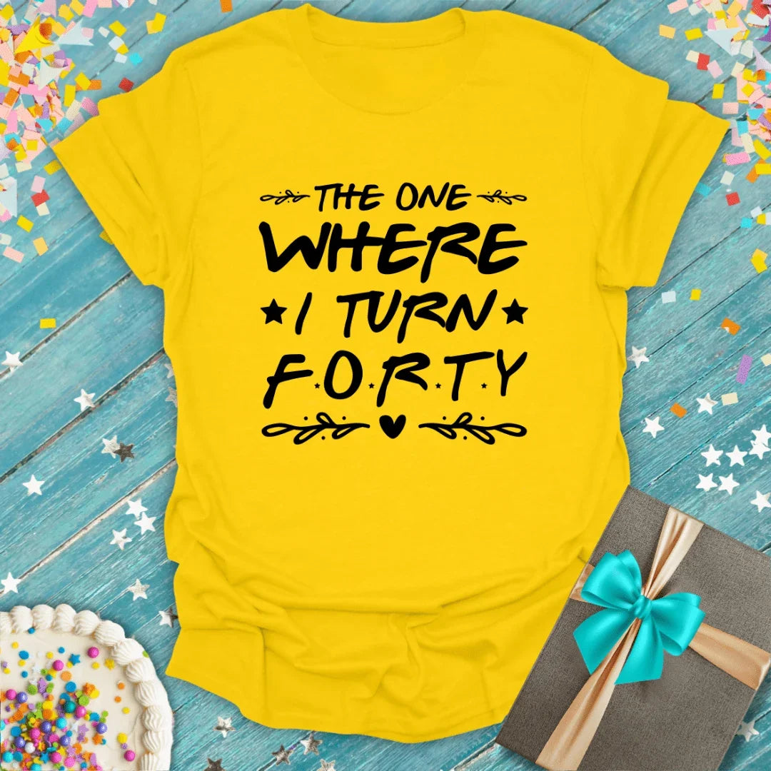 Yellow birthday tee saying 'The One Where I Turn Forty' with cake, gift, and confetti