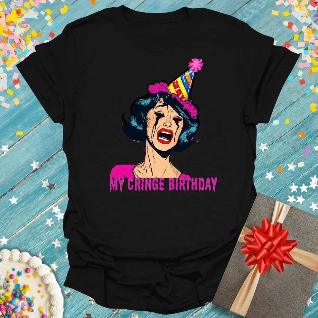 Black graphic tee with crying woman in party hat, 'My Cringe Birthday' text, cake & gift on blue wood