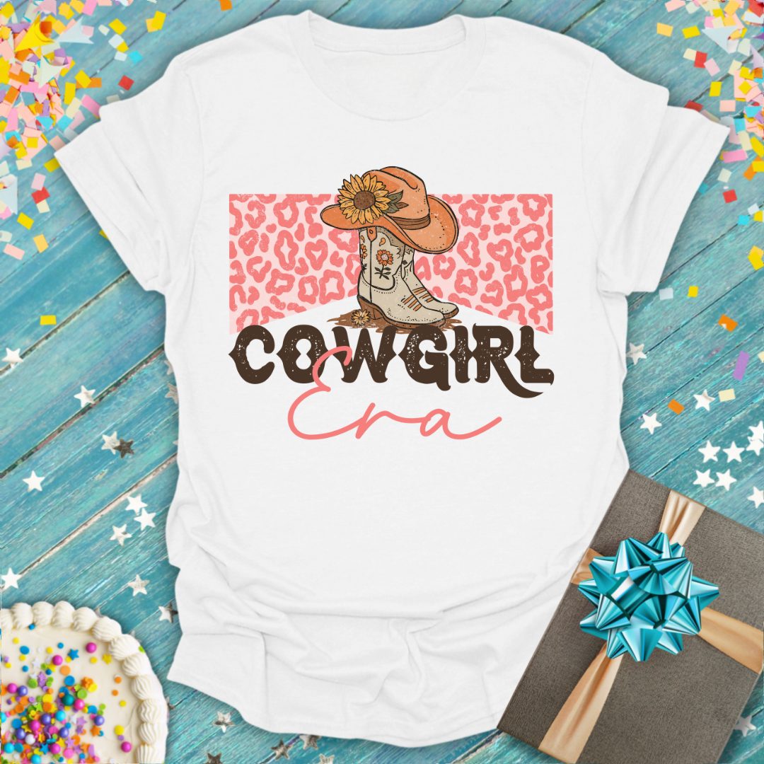 Epic Era Tees white Cowgirl ERA T-Shirt featuring a boot, hat, and leopard print graphic.