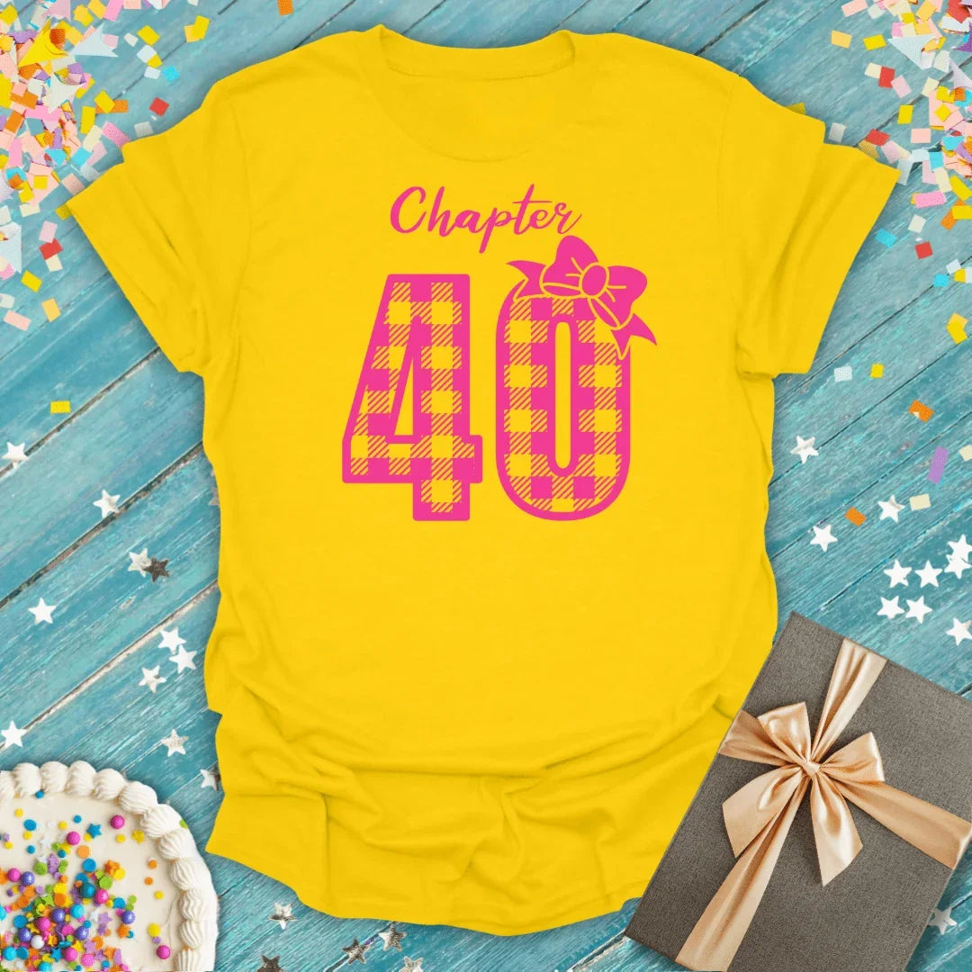 Yellow 'Chapter 40' birthday tee with pink plaid number, gift box, and confetti for milestone celebrations