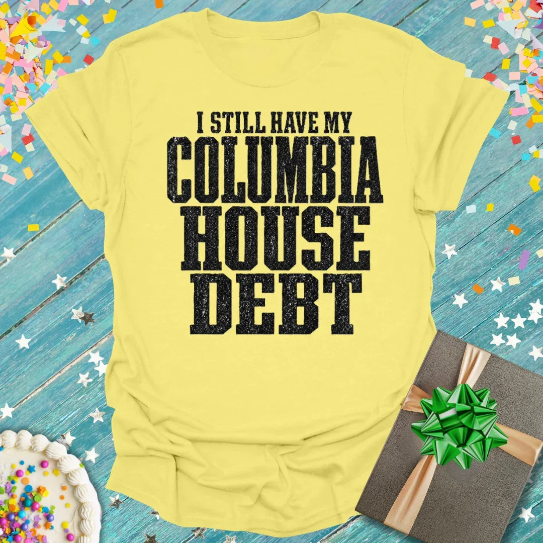 Yellow t-shirt with bold black 'I STILL HAVE MY COLUMBIA HOUSE DEBT' text, styled for milestone celebrations by Epic Era Tees.