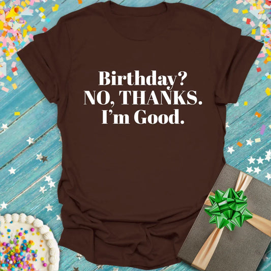 Brown t-shirt with bold white text 'Birthday? NO, THANKS. I’m Good.' by Epic Era Tees, styled with cake and gift.