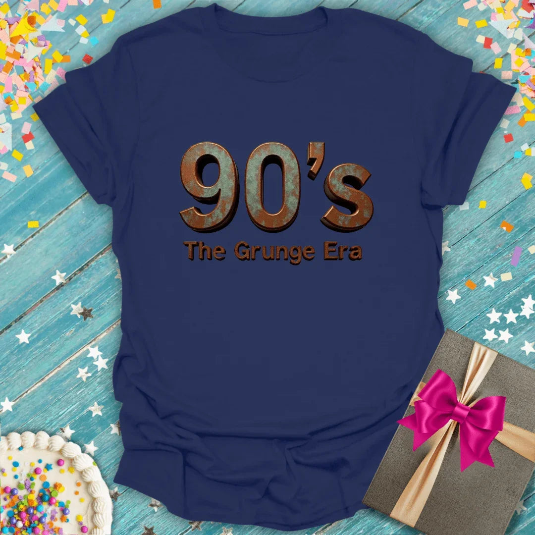 Navy 90s Grunge Era tee with rustic text, birthday cake, gift box, and confetti on blue wood