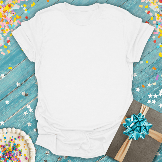 White t-shirt on a blue wooden surface with a gift and cake, surrounded by confetti. Short to be used for customization.