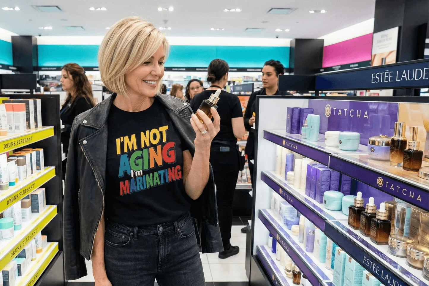 Woman in 'I'm Not Aging I'm Marinating' tee shopping skincare at beauty store