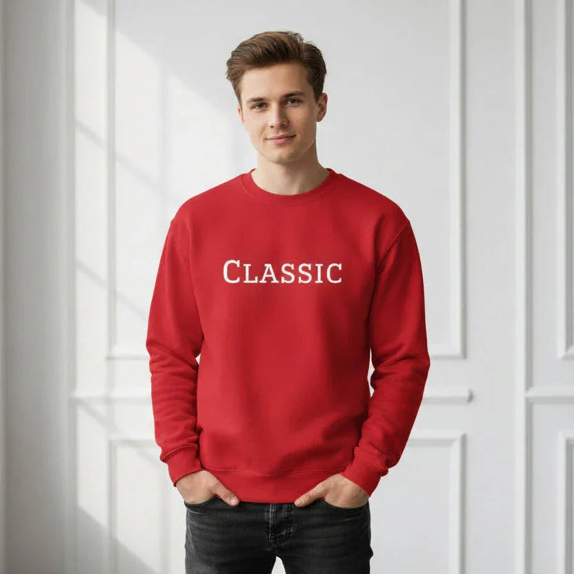 Man wearing red sweatshirt with 'Classic' embroidery in bright modern room
