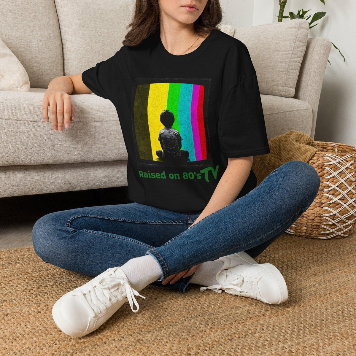 Black 'Raised on 80's TV' tee by Epic Era Tees featuring retro test pattern graphic with child silhouette and green text.