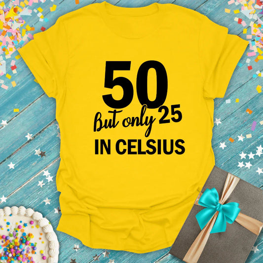 Yellow birthday T-shirt with '50 but only 25 in Celsius' text, confetti, cake, and gift box