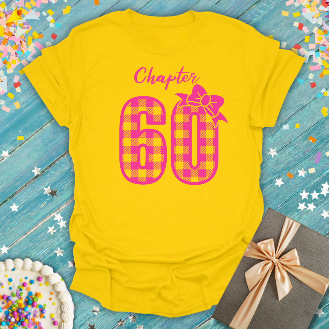 Yellow Printify t-shirt with 'Chapter 60' in pink buffalo check print and a bow graphic.