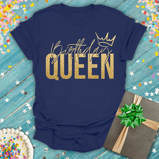 Navy blue Birthday Queen T-shirt with gold lettering and crown, surrounded by confetti, cake, and gift box.