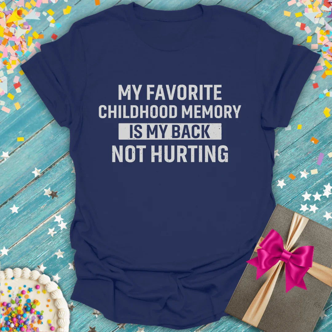 Navy blue funny birthday T-shirt with 'My favorite childhood memory is my back not hurting' text, surrounded by confetti, cake, and a gift box.