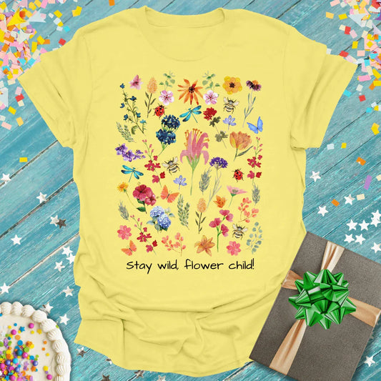 Yellow t-shirt with colorful wildflower, butterfly, and dragonfly print, text 'Stay wild, flower child!'