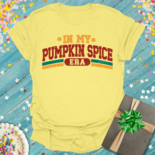 Yellow 'In My Pumpkin Spice Era' tee with gift box & cake, perfect for fall birthdays or trips