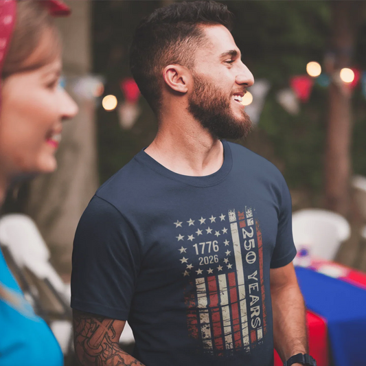 Man wearing navy 250 Years 1776-2026 patriotic tee at outdoor family celebration