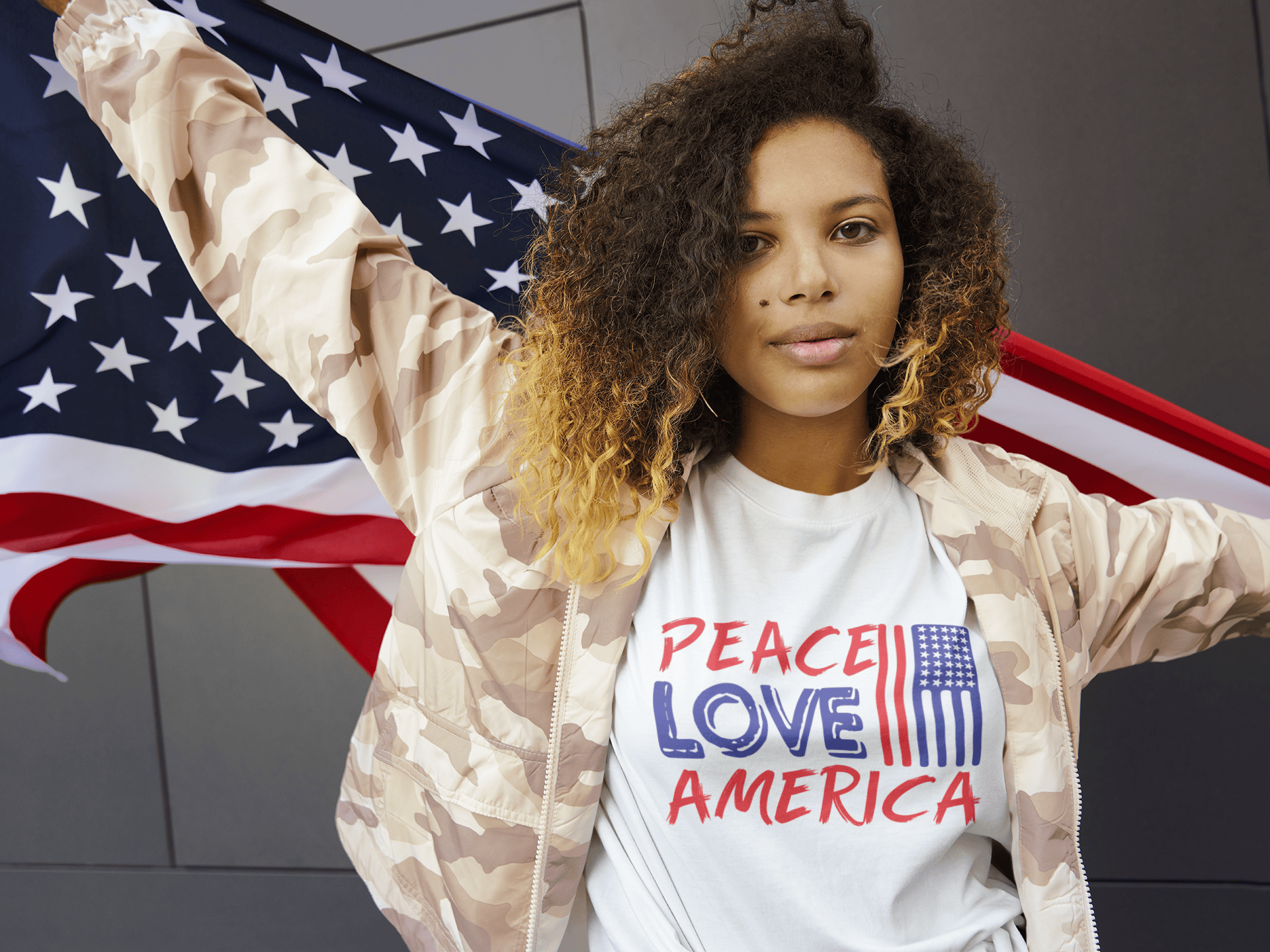 Woman wearing 'Peace Love America' tee with USA flag, soft graphic t-shirt for patriotic style
