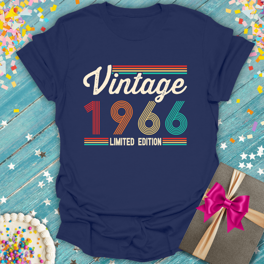 Vintage 1966 limited edition tee with retro stripes, birthday cake, and gift on blue wood