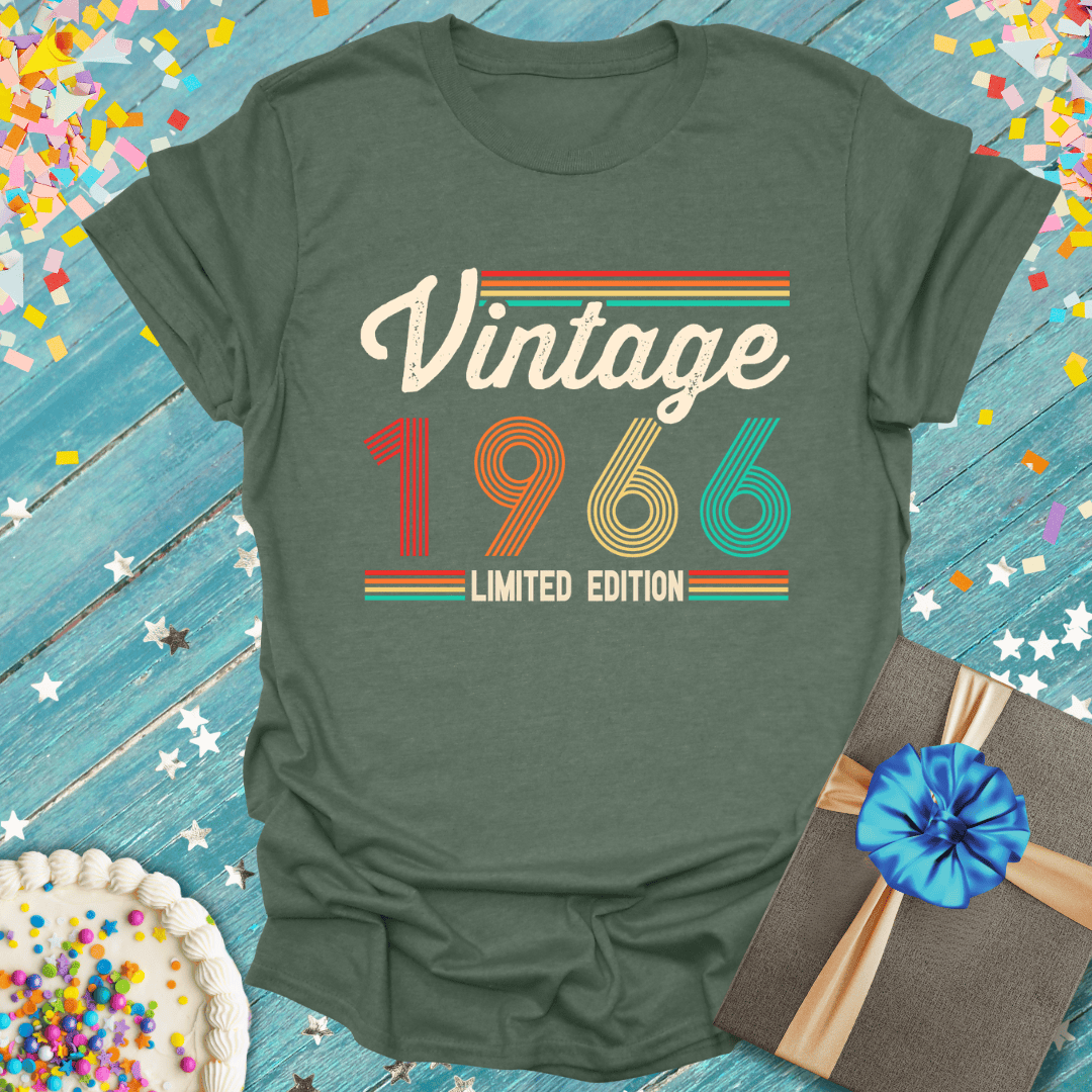 Vintage 1966 limited edition tee with retro stripes, birthday cake, and gift on blue wood