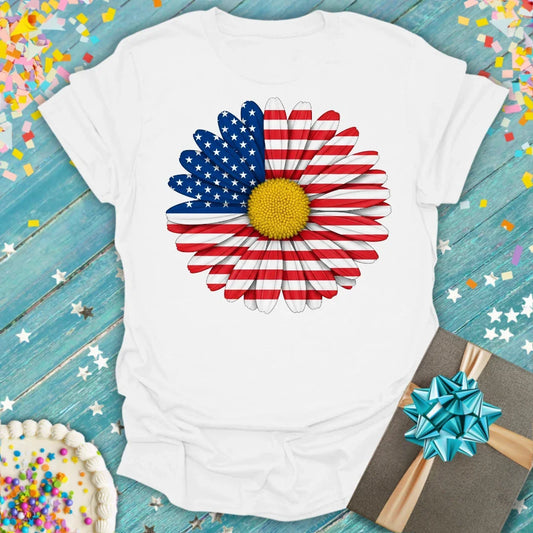 White t-shirt with American flag daisy graphic, yellow center, red/white stripes, blue stars. Epic Era Tees.