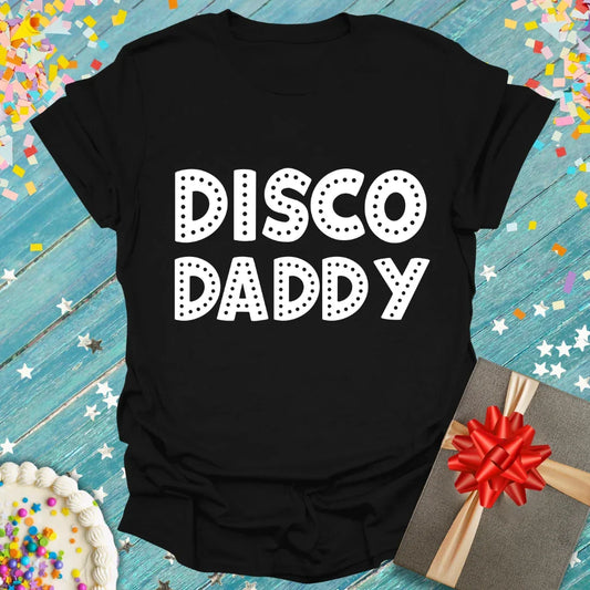 Black 'Disco Daddy' t-shirt with dotted white text, styled with confetti and gift, from Epic Era Tees.