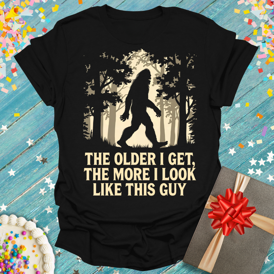 Epic Era Tees black t-shirt featuring a Bigfoot graphic and 'The Older I Get, The More I Look Like This Guy' text.
