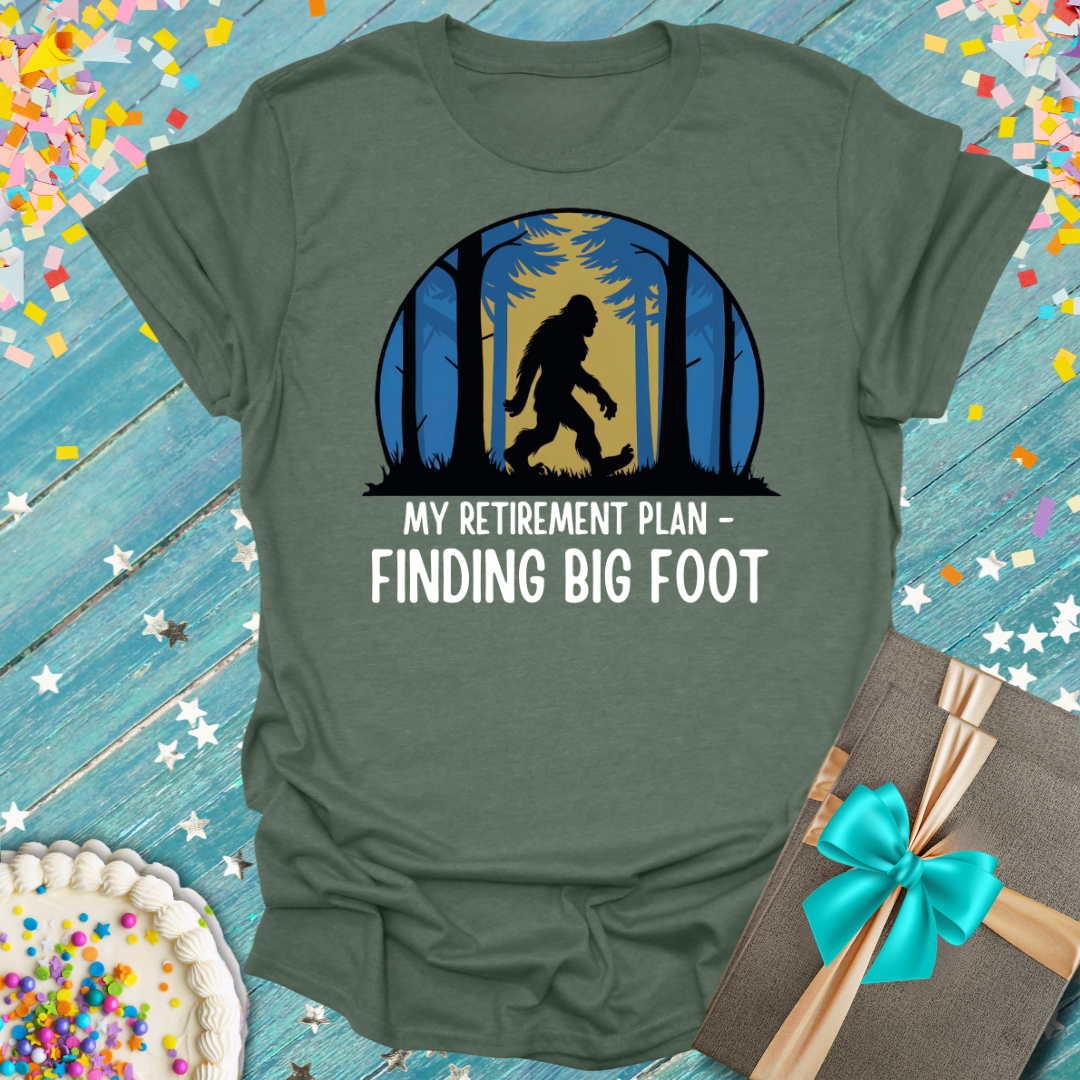 Epic Era Tees olive shirt featuring a Bigfoot silhouette in a forest with 'My Retirement Plan - Finding Big Foot' text.