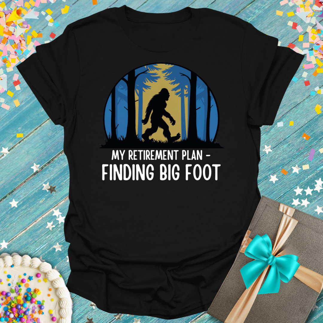 Epic Era Tees black t-shirt featuring a Bigfoot silhouette in woods with 'My Retirement Plan - Finding Big Foot' text.