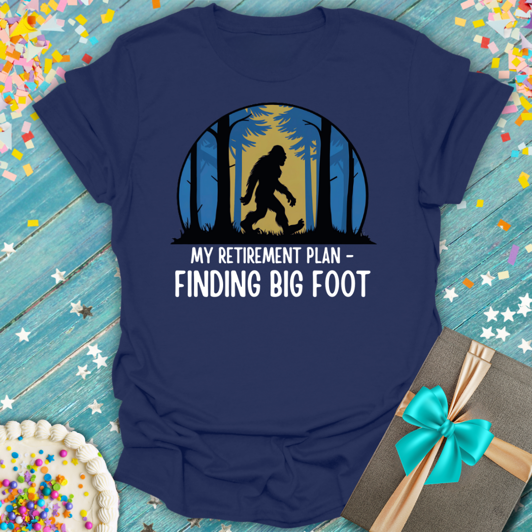Navy blue Epic Era Tees t-shirt featuring a Bigfoot forest graphic and 'My Retirement Plan - Finding Big Foot'.