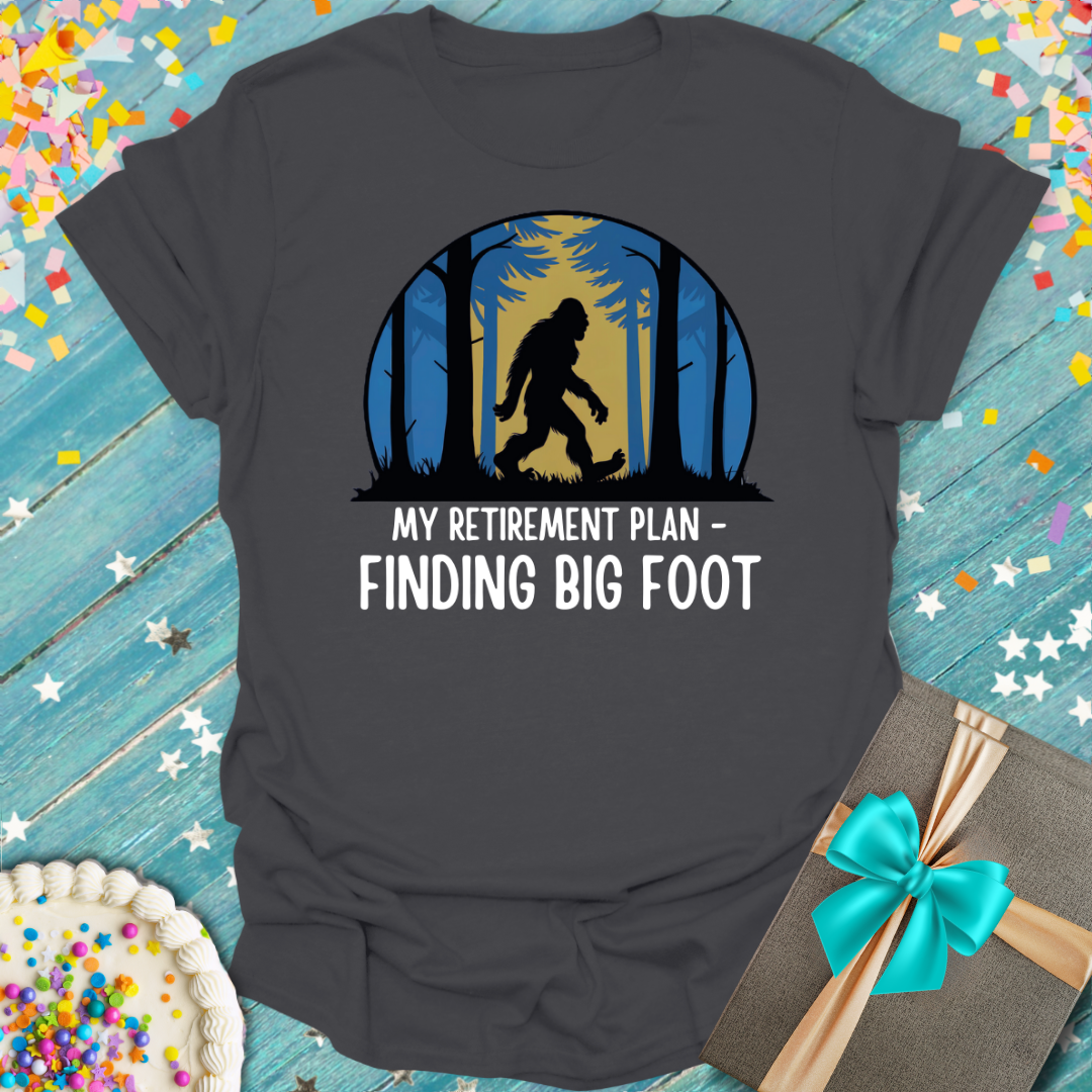 Epic Era Tees grey t-shirt featuring 'My Retirement Plan - Finding Big Foot' graphic with Bigfoot silhouette.