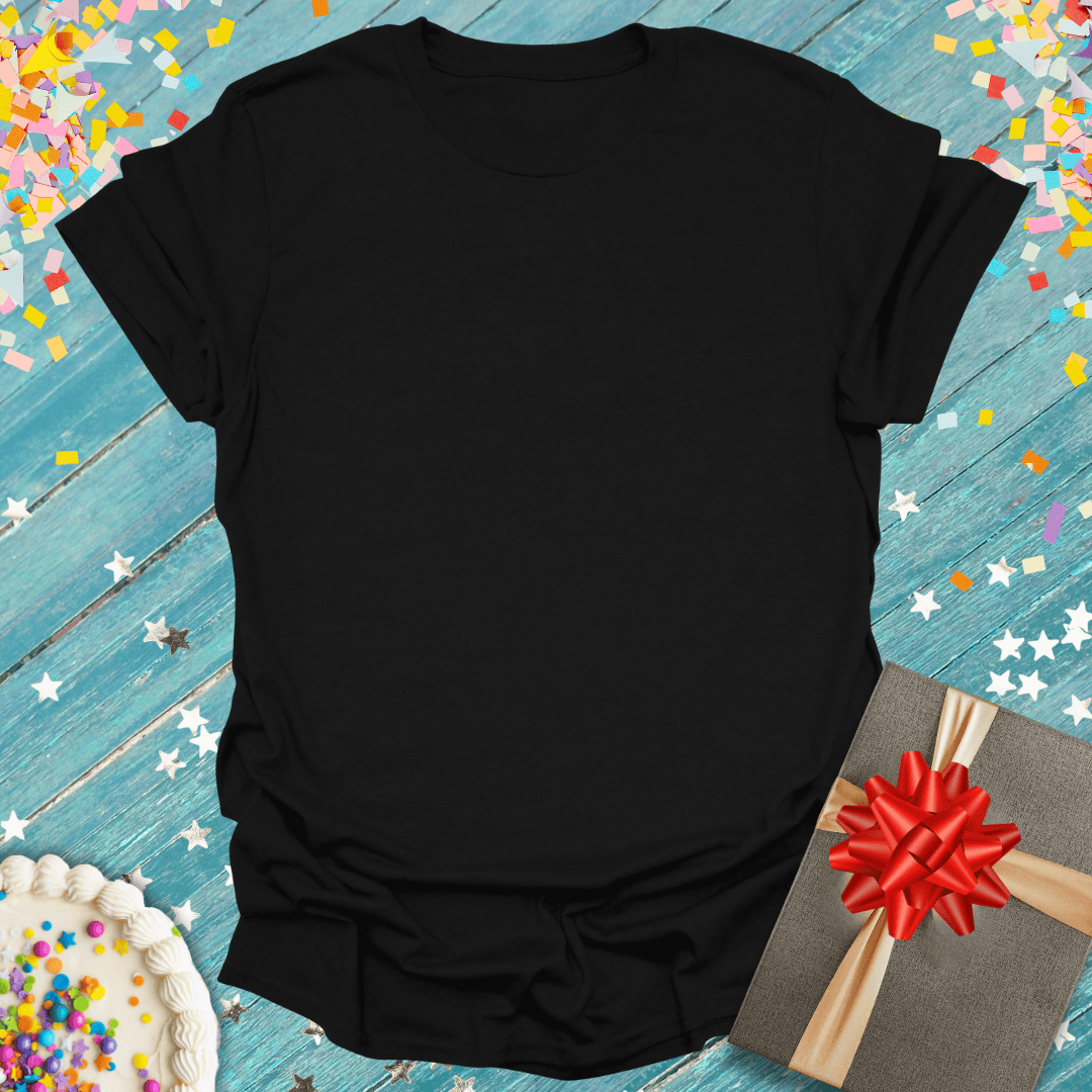Black blank tee with birthday cake, gift box, and confetti on blue wood — perfect for celebrations and gifts