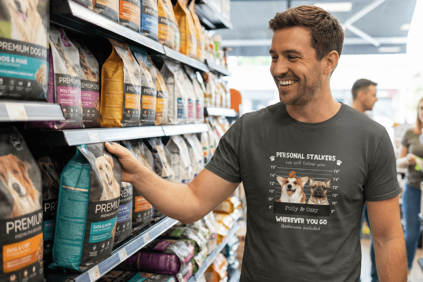 Man smiling in pet store wearing funny dog lover tee with 'Personal Stalkers' graphic, perfect for dog moms & dads.